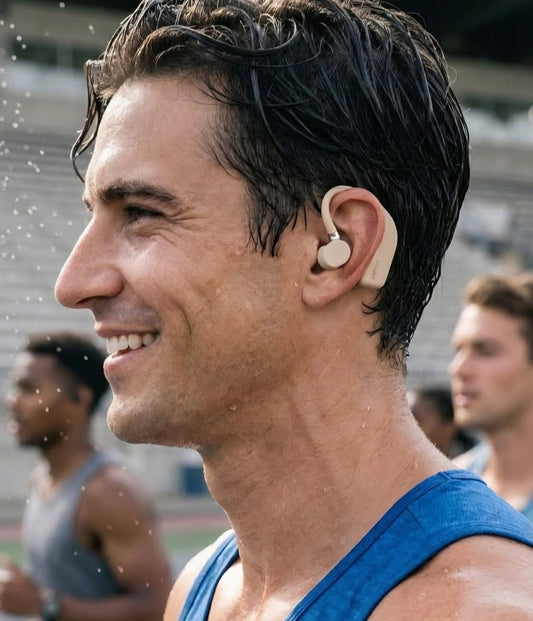 Man wearing a HaloFit headphone-inspired OTC hearing aid outdoors on a track.